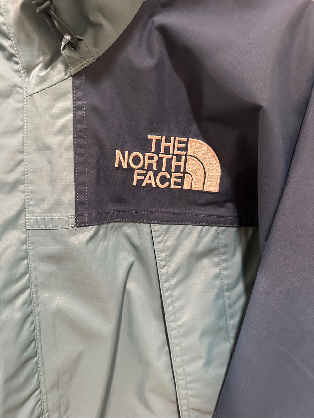 The North Face Two-Tone Raincoat in Light Teal and Navy Blue